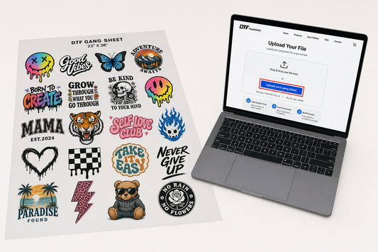 DTF gang sheet with multiple colorful designs laid on white table next to laptop showing upload button.